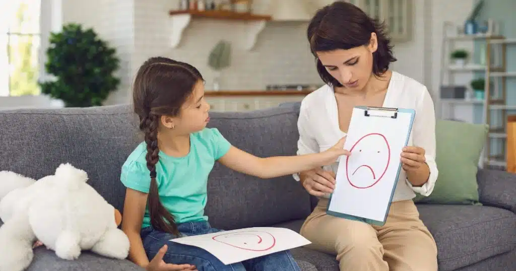 Child practicing emotional regulation with a therapist https://www.autismparentingmagazine.com/how-to-discipline-an-autistic-child-for-hitting/